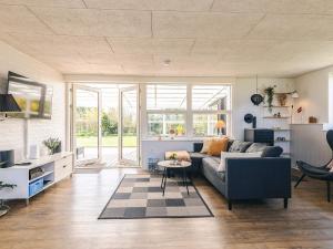 a living room with a couch and a table at 6 person holiday home in Vinderup-By Traum in Vinderup