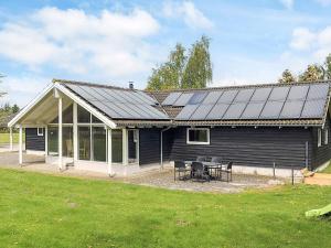 a house with solar panels on top of it at 12 person holiday home in Idestrup-By Traum in Bøtø By