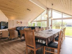 a dining room with a large wooden table and chairs at 12 person holiday home in Idestrup-By Traum in Bøtø By