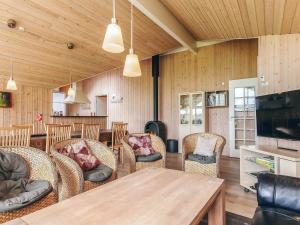 a living room with a table and chairs at 12 person holiday home in Idestrup-By Traum in Bøtø By