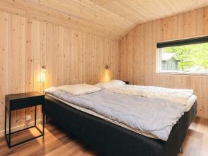 a bedroom with a bed in a room with a window at 12 person holiday home in Idestrup-By Traum in Bøtø By