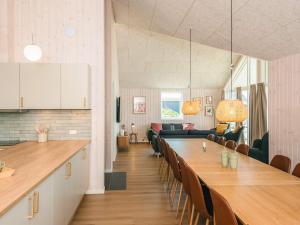a dining room with a long table and chairs at 5 star holiday home in Jerup in Jerup