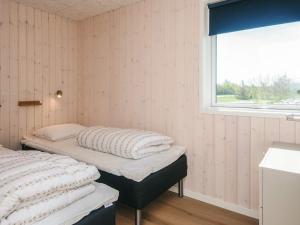 two beds in a room with a window at 5 star holiday home in Jerup in Jerup +25 photos