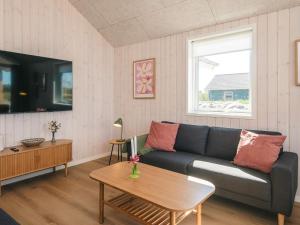 a living room with a couch and a table at 5 star holiday home in Jerup in Jerup