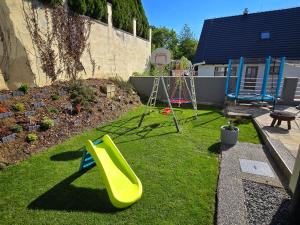 a backyard with a slide and a playground at Dom pri jazere Nitrianske Rudno in Kostolná Ves