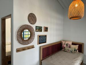 a room with a bed and a mirror on the wall at Donde Andres en la Playa in Necoclí