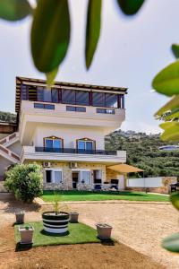 a large house with plants in front of it at Mathios Apartments Falassarna in Falasarna