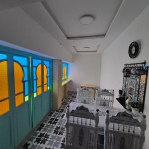 a room with two beds and a clock on the wall at dar Beya in Kairouan +10 photos