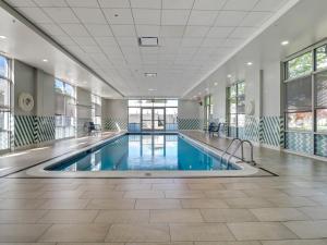 a swimming pool in a large building with windows at Holiday Inn - Piscataway - Somerset by IHG in Piscataway
