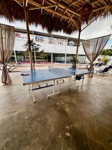 a ping pong table in the middle of a tennis court at La Pala Suites in Las Terrenas