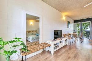 a living room with a couch a table and a mirror at Beachfront Bliss Studio Apt on the Foreshore in Nightcliff +14 photos
