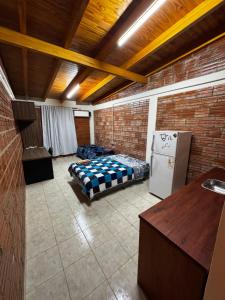 a room with a bed and a refrigerator in it at Departamento Davis in Eldorado