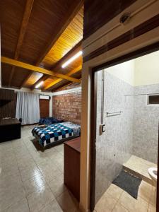 a bedroom with a bed and a shower and a bathroom at Departamento Davis in Eldorado