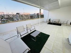 a group of chairs and tables in a room at PIAZZA COPERTA Casa Vacanza in Aradeo +10 photos