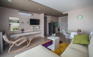 a living room with a couch and chairs in it at 7Seas in Jomtien Beach