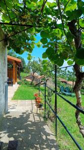 a fence next to a walkway with a tree at Apartamentos Rurales Sariar in Villar