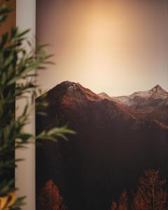 a mountain in the distance with the sun setting behind it at A-Apartment in Gjakove