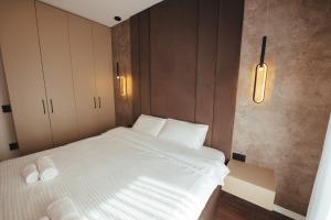 a bedroom with a bed with two towels on it at A-Apartment in Gjakove