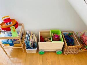 a room with wooden crates and shelves with toys at Koeda House in Tokyo