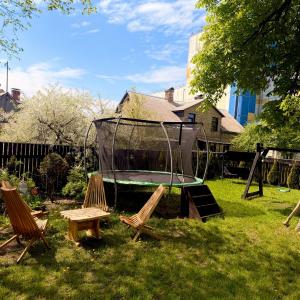 a group of chairs and a trampoline in a yard at Vadim Home in Ventspils