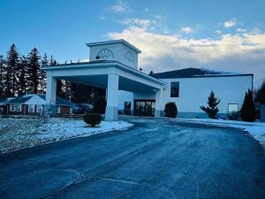 a large white building with a clock tower on it at Hotel M Mount Pocono in Mount Pocono