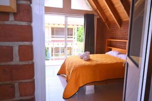 a bedroom with a bed with a teddy bear on it at Hotel Ensueño del Bosque Valle de Bravo in Valle de Bravo +16 photos