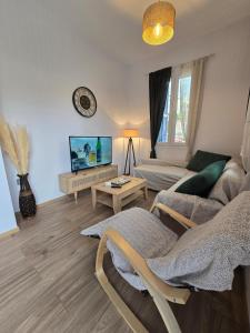 a living room with a couch and a tv at Stone House with Panoramic Views in Marmaro in Mármaron