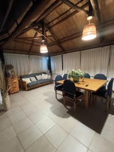 a dining room with a table and chairs and a bed at Fabulosa y confortable cabaña in Mendoza +22 photos