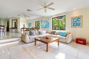 a living room with a couch and a table at Recently Renovated Luxury Condo with Resort-Style Beach Club Access and Ocean Views in Playa Conchal