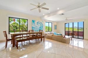 a living room with a dining table and a couch at Recently Renovated Luxury Condo with Resort-Style Beach Club Access and Ocean Views in Playa Conchal