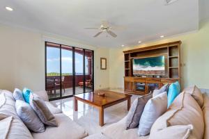 a living room with a couch and a table at Recently Renovated Luxury Condo with Resort-Style Beach Club Access and Ocean Views in Playa Conchal