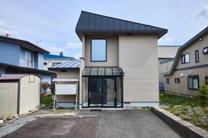 a house with a black roof at Furano Lavender House helps guests book great restaurants in Furano in Furano