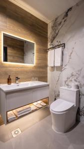 a white bathroom with a sink and a toilet at Hotel Biser in Kališta +17 photos