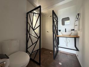 a bathroom with a white toilet and a sink at Altavista Cabin Rest House in Barbosa +28 photos