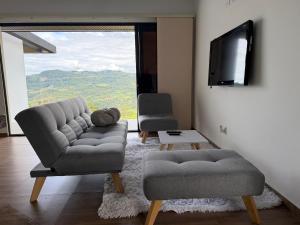 a living room with a couch and a tv at Altavista Cabin Rest House in Barbosa