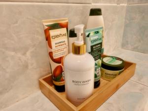 a wooden shelf with bottles of soap and other products at Bed and Break fast JIREH in Casalecchio di Reno