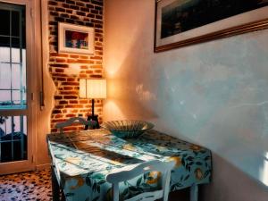 a dining room with a table and chairs and a brick wall at Bed and Break fast JIREH in Casalecchio di Reno