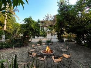 a fire pit in a yard with chairs around it at Hotel Verdemar in Acapulco