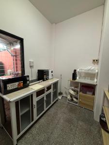 a kitchen with white walls and a counter top at Aonang Poonsiri Cozy Villa in Ban Khlong Haeng