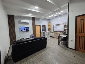 a living room with a black couch and a table at Casa en Lanco in Lanco