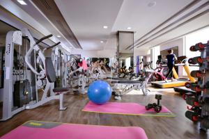 a gym with exercise equipment and a blue ball on the floor at Pickalbatros White Beach Resort - Hurghada in Hurghada