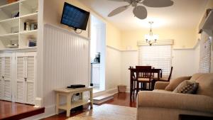 a living room with a couch and a tv on a wall at Lakeview Retreat in Cape May Point