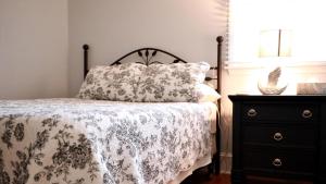 a bedroom with a bed and a dresser at Lakeview Retreat in Cape May Point