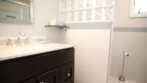 a bathroom with a sink and a shower at Lakeview Retreat in Cape May Point +20 photos