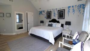a bedroom with a bed and blue wallpaper at West Cape Oasis in West Cape May +33 photos