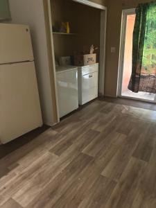 a kitchen with a refrigerator and wooden floors at Pixie hollow single vacation retreat resort space in Orlando