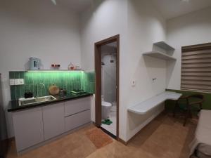 a bathroom with a sink and a tub and a toilet at An House Son Tra in Danang