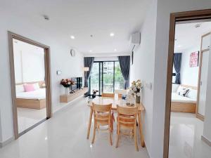 a dining room and living room with a table and chairs at Hiền Apartment in Thôn Văn Dương