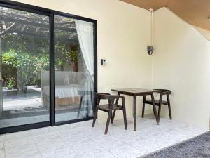 a dining room with a table and two chairs at Wilawan home in Ko Samui