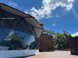 a glass pavilion with a blue sky in the background at Glamping oriente antioqueño in San Vicente +7 photos